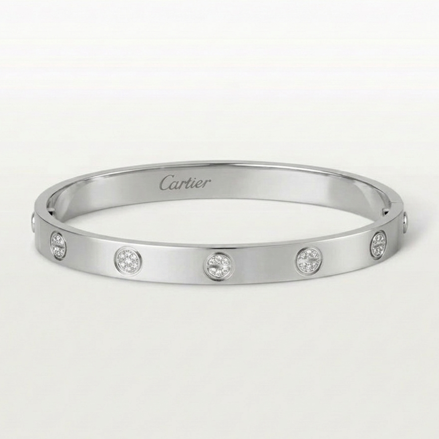 Silver bracelet with diamonds on a white background, featuring the Cartier logo.